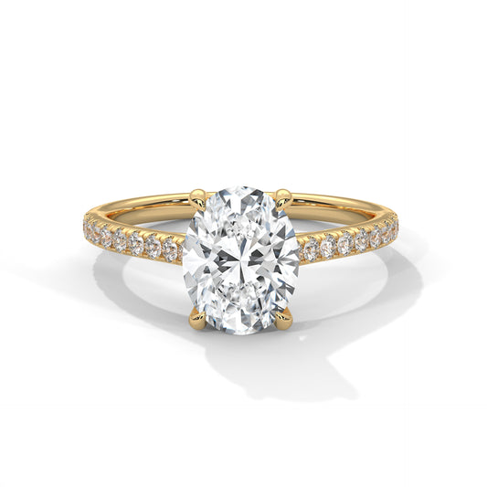 Gold ring with a large diamond and smaller diamonds on the band against a white background