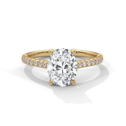 Gold ring with a large diamond and smaller diamonds on the band against a white background