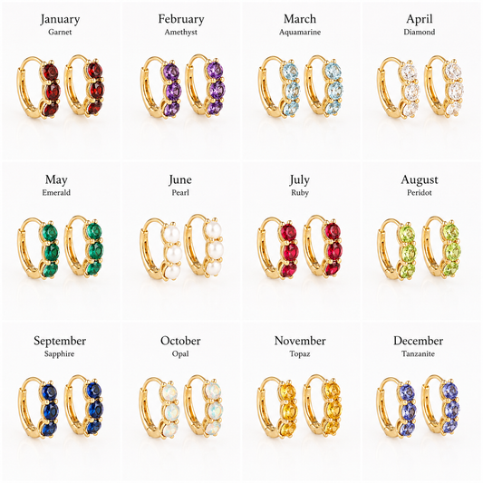 A 12-grid jewelry chart showing gold huggie hoop earrings with gemstone rows labeled by month and gem name. The earrings include garnet, amethyst, aquamarine, diamond, emerald, pearl, ruby, peridot, sapphire, opal, topaz, and tanzanite in gold-tone settings.