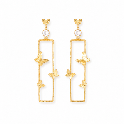 A pair of gold-toned dangle earrings with a tall rectangular open frame, small butterfly motifs, and a clear round crystal at the top, shown on a plain white background.