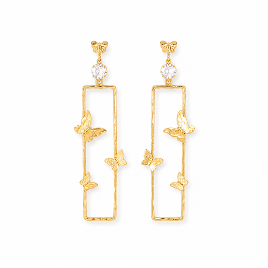 A pair of gold-toned dangle earrings with a tall rectangular open frame, small butterfly motifs, and a clear round crystal at the top, shown on a plain white background.